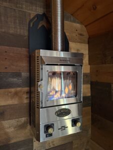 Dickinson Marine propane fireplace in custom skoolie conversion