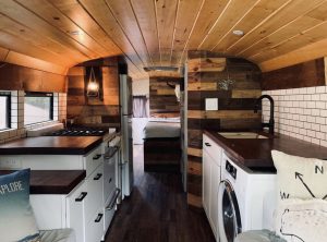 Inside custom skoolie conversion with cabin vibes